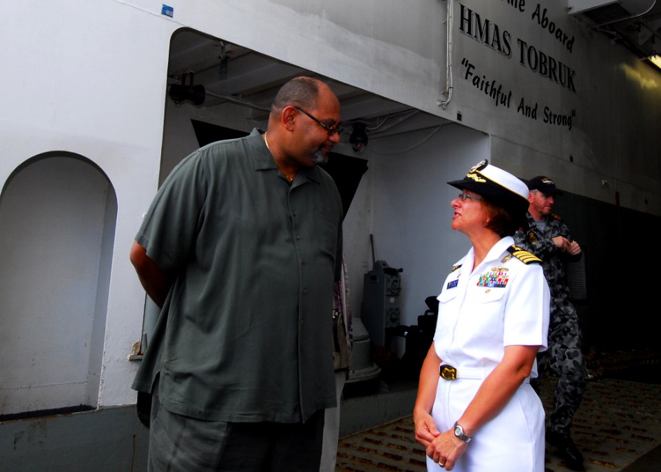 US Navy 100831-N-4044H-164 Teddy Taylor and Capt. Lisa M. Franchetti talk as he arrives aboard the Royal Australian Navy landing ship heavy HMAS Tobruk (L50)