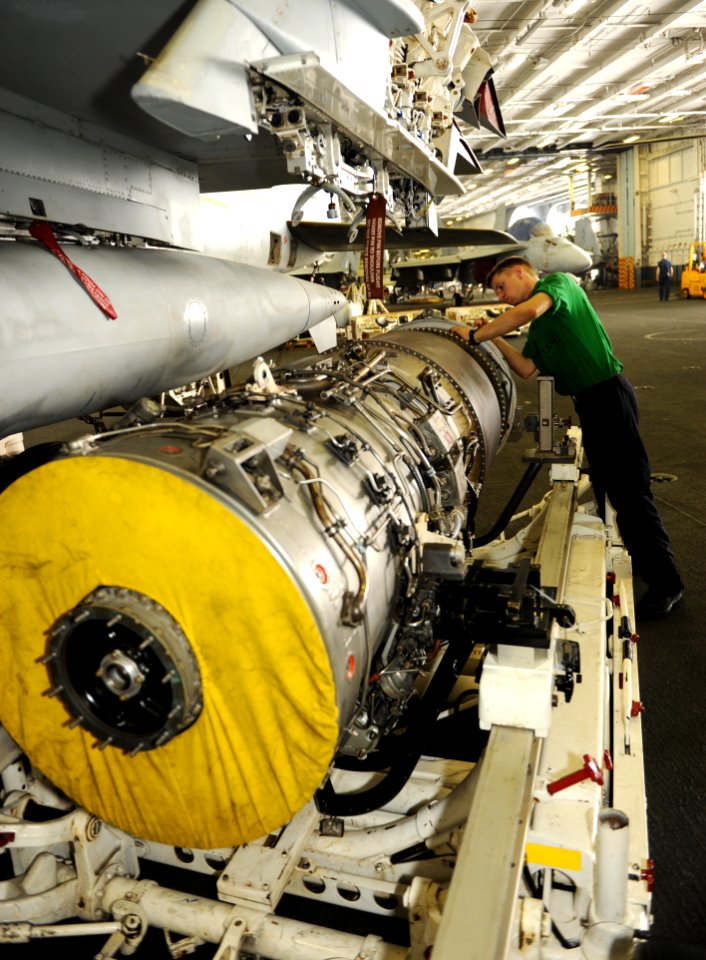 US Navy 100831-N-6362C-057 Aviation Machinist's Mate Airman Levi Campbell emoves the rear assembly of an EA-6B Prowler engine