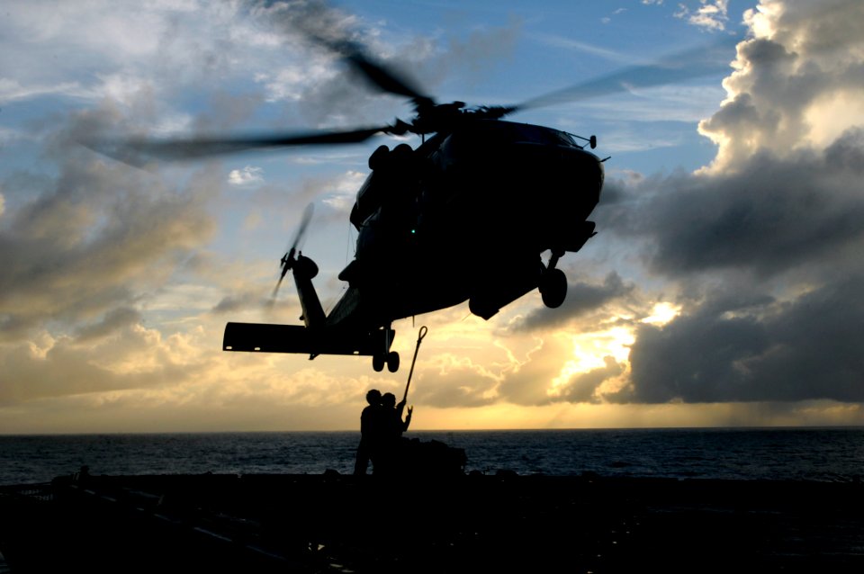 US Navy 100829-N-7478G-675 Sailors attach cargo to a SH-60F Sea Hawk helicopter aboard USS Blue Ridge (LCC 19)