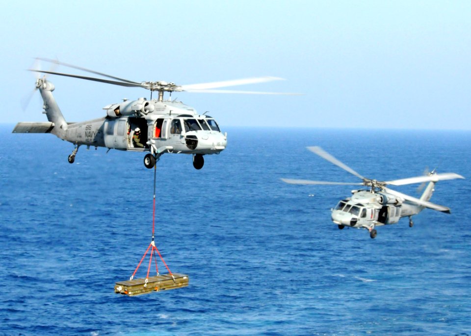 US Navy 100830-N-6632S-266 MH-60S Sea Hawk helicopters assigned to Helicopter Sea Combat Squadron (HSC) 9 embarked aboard the aircraft carrier USS George H.W. Bush (CVN 77), carry supplies during a vertical replenishment