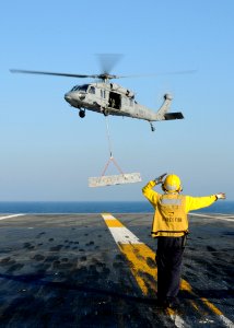 US Navy 100830-N-2686K-060 A Sailor assigned to the air department aboard the aircraft carrier USS George H.W. Bush (CVN 77) directs an MH-60S Sea Hawk helicopter assigned to Helicopter Sea Combat Squadron (HSC) 9 during an amm