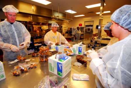 US Navy 100901-N-2903M-027 Sailors pack food for distribution to various locations throughout the Cleveland metropolitan area during a Cleveland Navy Week community service event
