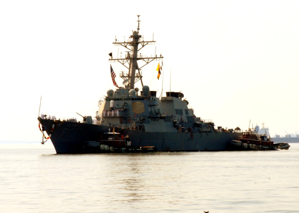 US Navy 100901-N-5292M-007 Tug boats guide the guided-missile destroyer USS Cole (DDG 67) to the pier as the ship returns to Naval Station Norfolk