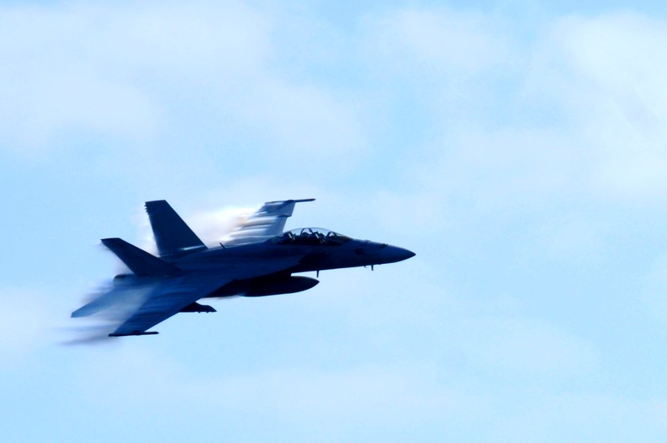 US Navy 100830-N-2918M-048 Capt. Scott Conn, accompanied by Rear Adm. Robert Girrier, breaks the sound barrier during a fly-by over USS Nimitz (CVN 68)