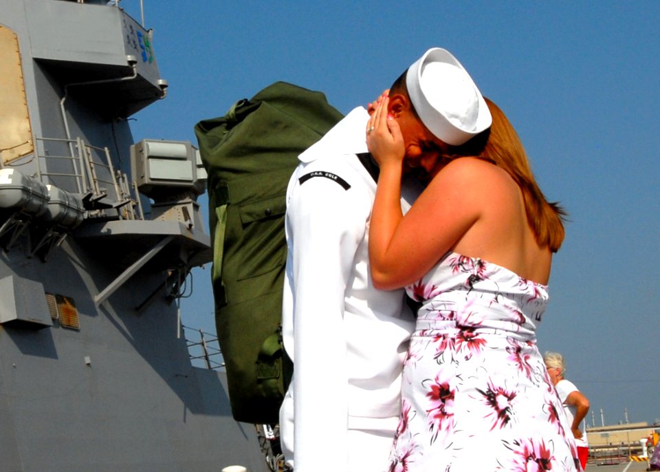 US Navy 100901-N-5292M-150 Fire Controlman 2nd Class Steven Johnson greets his wife during a homecoming celebration for the guided-missile destroyer USS Cole (DDG 67)