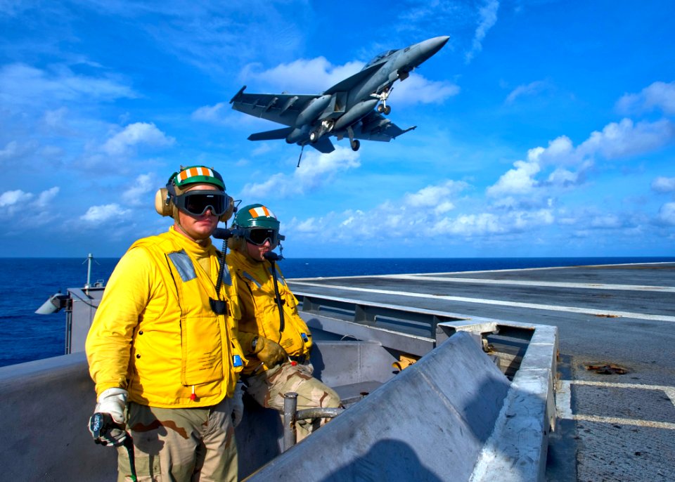 US Navy 100830-N-6720T-152 Landing signal officers direct An F-A-18 Hornet to a landing aboard the aircraft carrier USS George Washington (CVN 73)