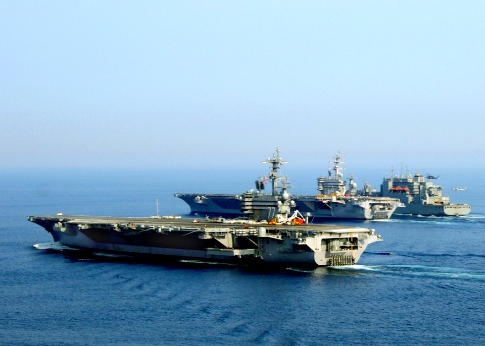 US Navy 100901-N-9793B-037 The aircraft carriers USS George H.W. Bush (CVN 77), front, and USS Dwight D. Eisenhower (CVN 69) conduct a vertical replenishment with the Military Sealift Command dry cargo and ammunition ship USNS