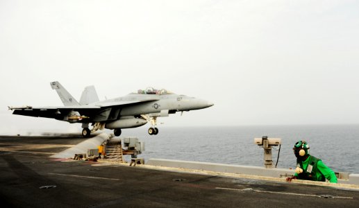 US Navy 100901-N-6362C-144 Aviation Boatswain's Mate (Equipment) Airman Milton Holt watches an F-A-18F Super Hornet launch from the aircraft carrier USS Harry S. Truman (CVN 75)