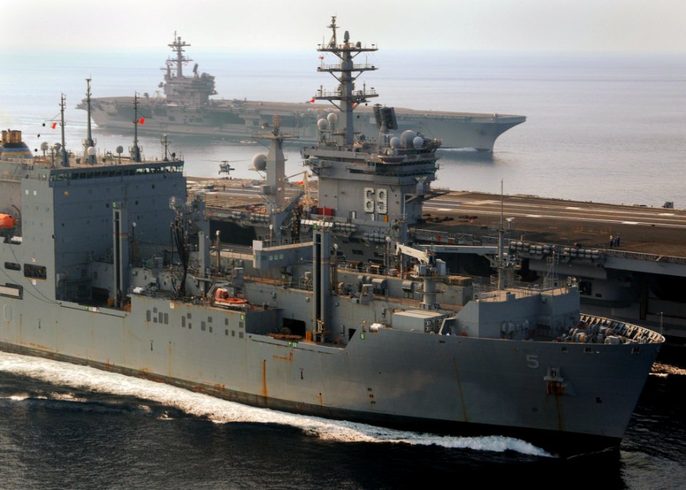US Navy 100901-N-9793B-054 The aircraft carriers USS Dwight D. Eisenhower (CVN 69), center, and USS George H.W. Bush (CVN 77) conduct a vertical replenishment with the Military Sealift Command dry cargo and ammunition ship USNS