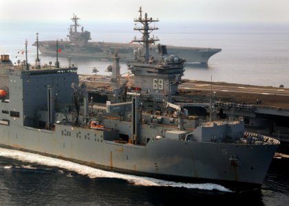 US Navy 100901-N-9793B-054 The aircraft carriers USS Dwight D. Eisenhower (CVN 69), center, and USS George H.W. Bush (CVN 77) conduct a vertical replenishment with the Military Sealift Command dry cargo and ammunition ship USNS