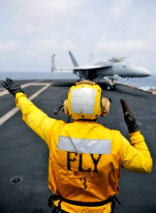 US Navy 100831-N-6003P-134 viation Boatswain's Mate (Handling) 2nd Class Dalix Mondestin, an aircraft director, guides an F-A-18E Super Hornet assigned to the Gunslingers of Strike Fighter Squadron (VFA) 105