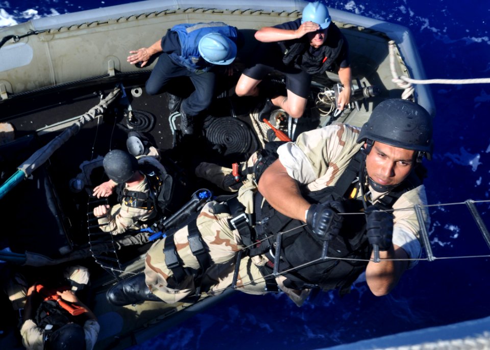 US Navy 100902-N-3620B-280 Boatswain's Mate 2nd Class Nolberto F. Donate climbs a Jacob's ladder during a visit, board, search and seizure drill aboard the amphibious transport dock ship USS Denver (LPD 9)