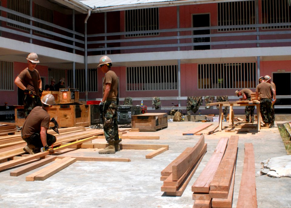 US Navy 100902-N-4971L-016 Seabees assigned to Naval Mobile Construction Battalion (NMCB) 7 embarked aboard High Speed Vessel Swift (HSV 2), build an additional classroom structure at Plaisance Community High School