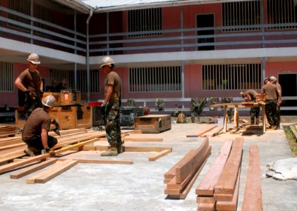 US Navy 100902-N-4971L-016 Seabees assigned to Naval Mobile Construction Battalion (NMCB) 7 embarked aboard High Speed Vessel Swift (HSV 2), build an additional classroom structure at Plaisance Community High School photo