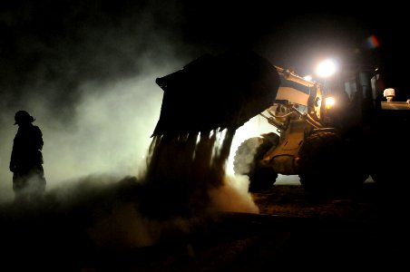 US Navy 100902-N-0475R-348 A Seabee assigned to Naval Mobile Construction Battalion (NMCB) 5 places fill with a front-end loader on a project at Camp Leatherneck, Afghanistan