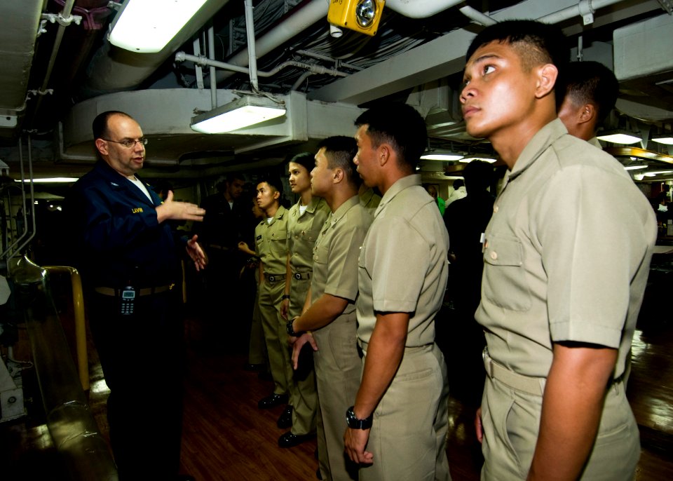 US Navy 100902-N-4830B-027 Recent graduates of the Philippine Military Academy listen as Capt. Joseph Lavan, senior medical officer aboard the aircraft carrier USS George Washington (CVN 73), explains how ordinance elevators ca