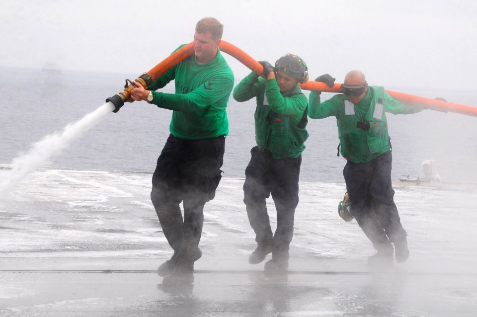 US Navy 100902-N-7488A-889 Sailors scrub the flight deck during a scrubbing exercise aboard USS Carl Vinson (CVN 70)