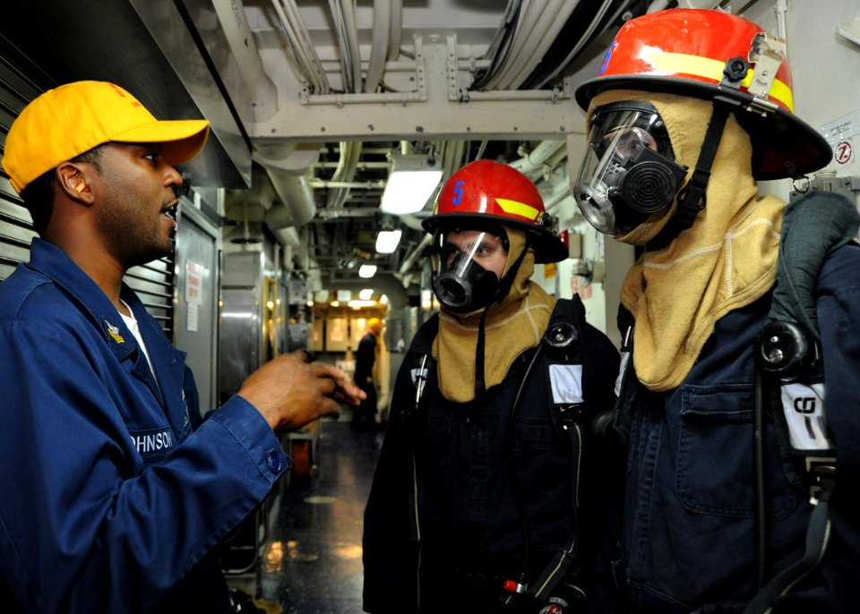 US Navy 100904-N-3705H-494 Navy Counselor 1st Class Carl Johnson trains Sailors on basic damage control during a damage control drill aboard USS Winston S. Churchill (DDG 81)