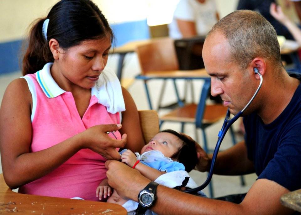 US Navy 100906-N-1531D-004 Lt. Cmdr. Jason Higginson, from Los Angeles, exams an infant during a Continuing Promise 2010 medical civic event