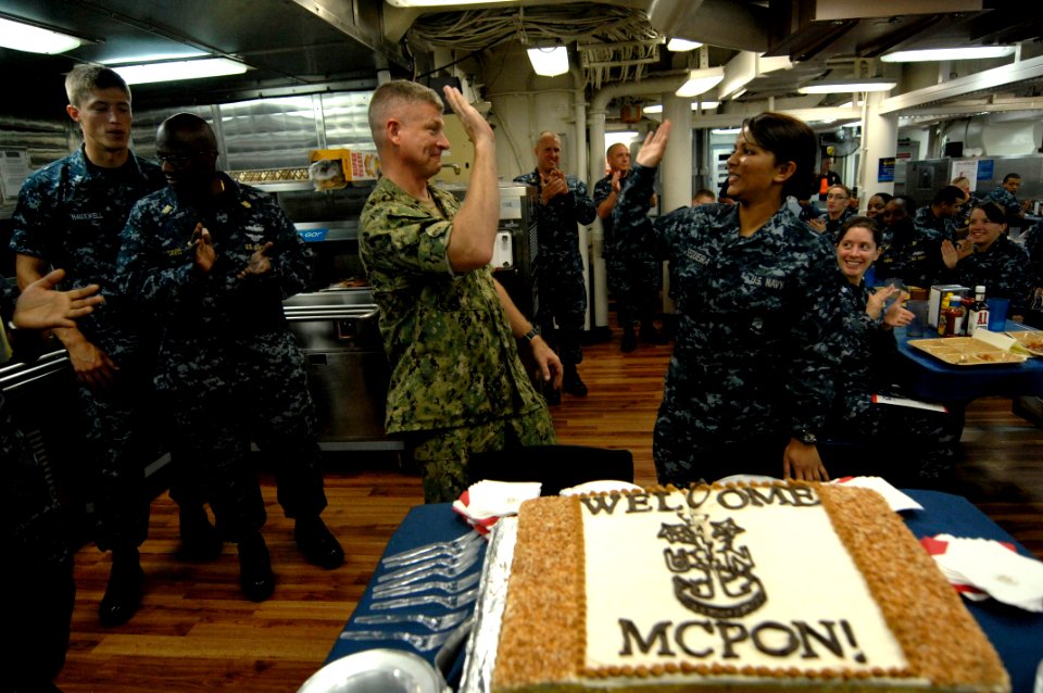 US Navy 100831-N-9818V-374 Master Chief Petty Officer of the Navy (MCPON) Rick West gives a high-five to the youngest Sailor aboard the guided-missile destroyer USS Lassen (DDG 82)
