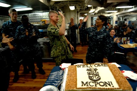 US Navy 100831-N-9818V-374 Master Chief Petty Officer of the Navy (MCPON) Rick West gives a high-five to the youngest Sailor aboard the guided-missile destroyer USS Lassen (DDG 82)