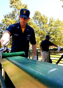 US Navy 100901-N-1004S-493 Chief Aviation Electronics Technician (Sel.) Justin Franklin, assigned to the aircraft carrier USS Ronald Reagan (CVN 76), paints the hand rail of a foot bridge at the Ronald Reagan Sports Park