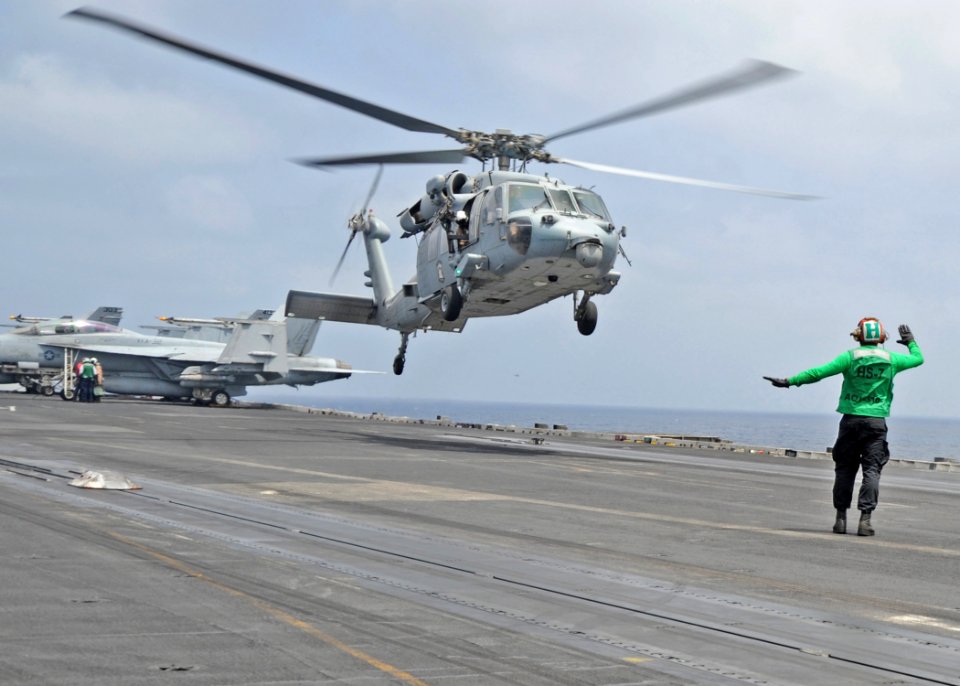 US Navy 100907-N-6427M-060 A Sailor gives helicopter landing signals to the pilot of a SH-60F Sea Hawk helicopter aboard USS Harry S. Truman (CVN 7