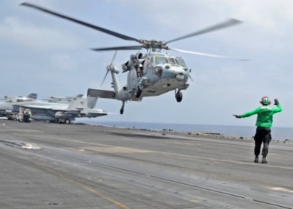 US Navy 100907-N-6427M-060 A Sailor gives helicopter landing signals to the pilot of a SH-60F Sea Hawk helicopter aboard USS Harry S. Truman (CVN 7