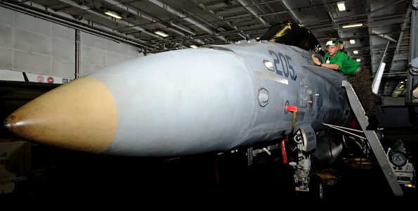 US Navy 100906-N-6427M-109 Lance Cpl. Thomas Jacobs cleans an F-A 18C Hornet while performing daily corrosion prevention maintenance aboard USS Har