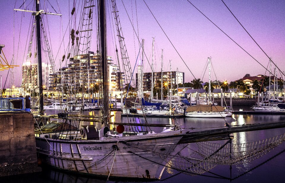 Sunset city lights old sailing boat