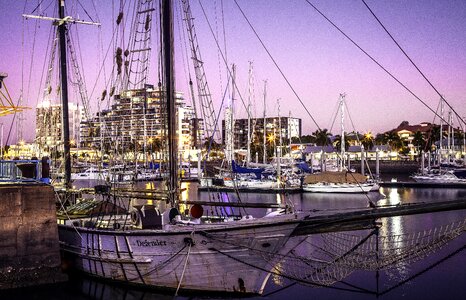 Sunset city lights old sailing boat
