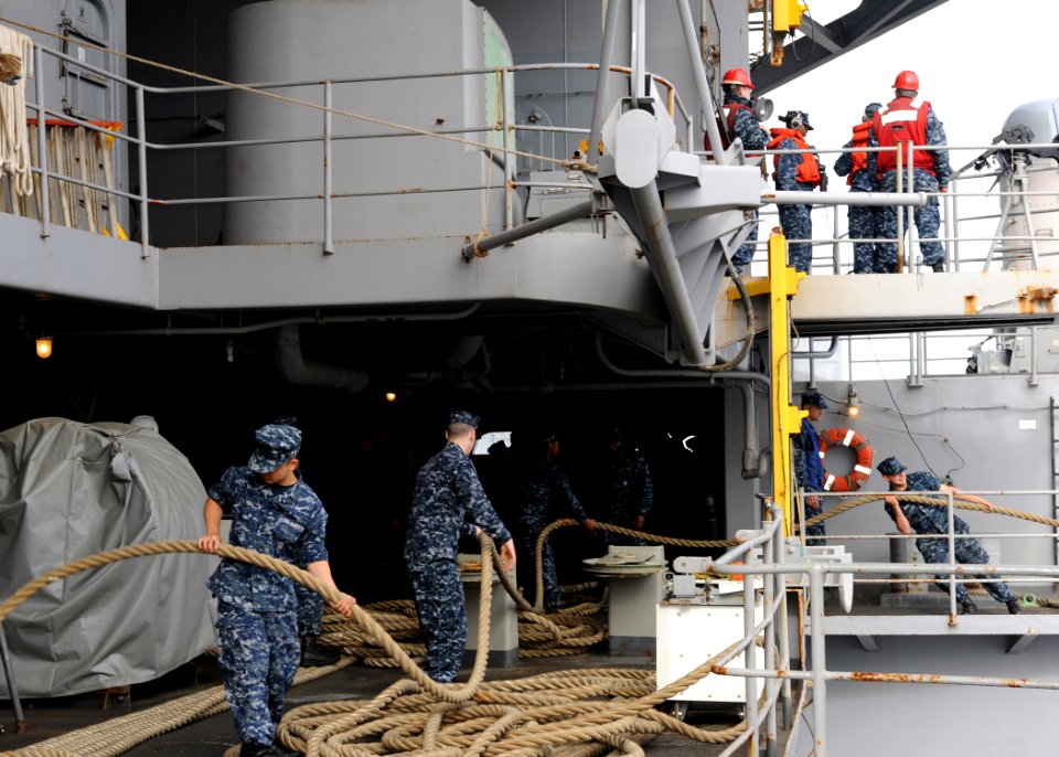 US Navy 100907-N-4973M-067 Sailors aboard the aircraft carrier USS Abraham Lincoln (CVN 72) heave mooring lines prior to departing homeport for a s