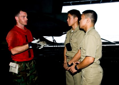 US Navy 100902-N-4830B-024 Aviation Ordnanceman 2nd Class John Petersen, from Eugene, Ore., speaks with recent graduates of the Philippine Military Academy about shipboard life during a tour of the aircraft carrier USS George W