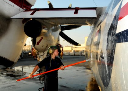 US Navy 100902-N-1092P-784 Aviation Structural Mechanic 3rd Class Bianca Islas ses a wash-stick to clean a C-2A Greyhound during a post-flight wash-down