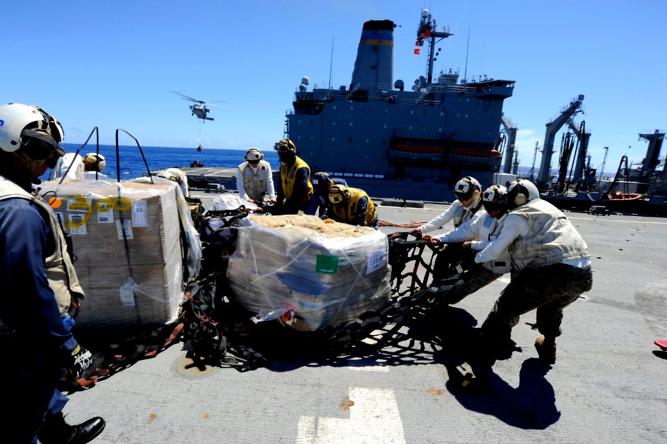 US Navy 100908-N-8335D-375 Marines move stores from a replenishment at sea across the flight deck aboard USS Harpers Ferry (LSD 49)