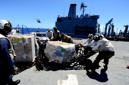 US Navy 100908-N-8335D-375 Marines move stores from a replenishment at sea across the flight deck aboard USS Harpers Ferry (LSD 49)