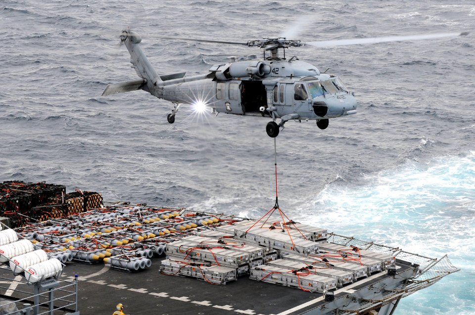 US Navy 100909-N-0232G-101 An MH-60S Sea Hawk helicopter lifts ordnance off the deck of the Military Sealift Command fast combat support ship USNS