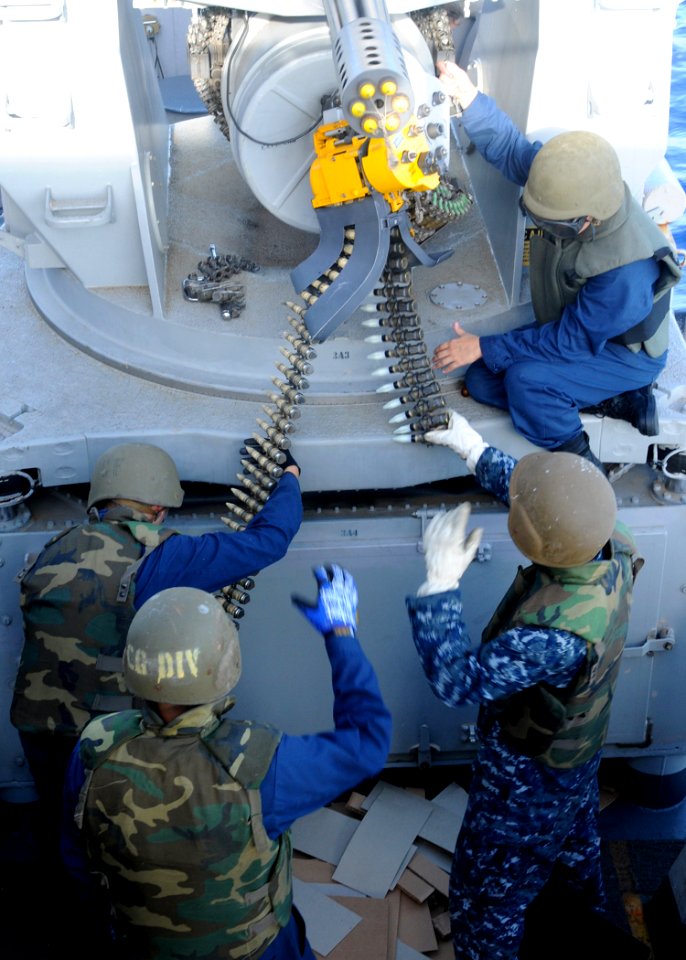 US Navy 100902-N-5538K-001 Sailors assigned to the forward-deployed amphibious assault ship USS Essex (LHD 2) load ammunition into a MK 15 Phalanx Close-In Weapons System (CIWS)