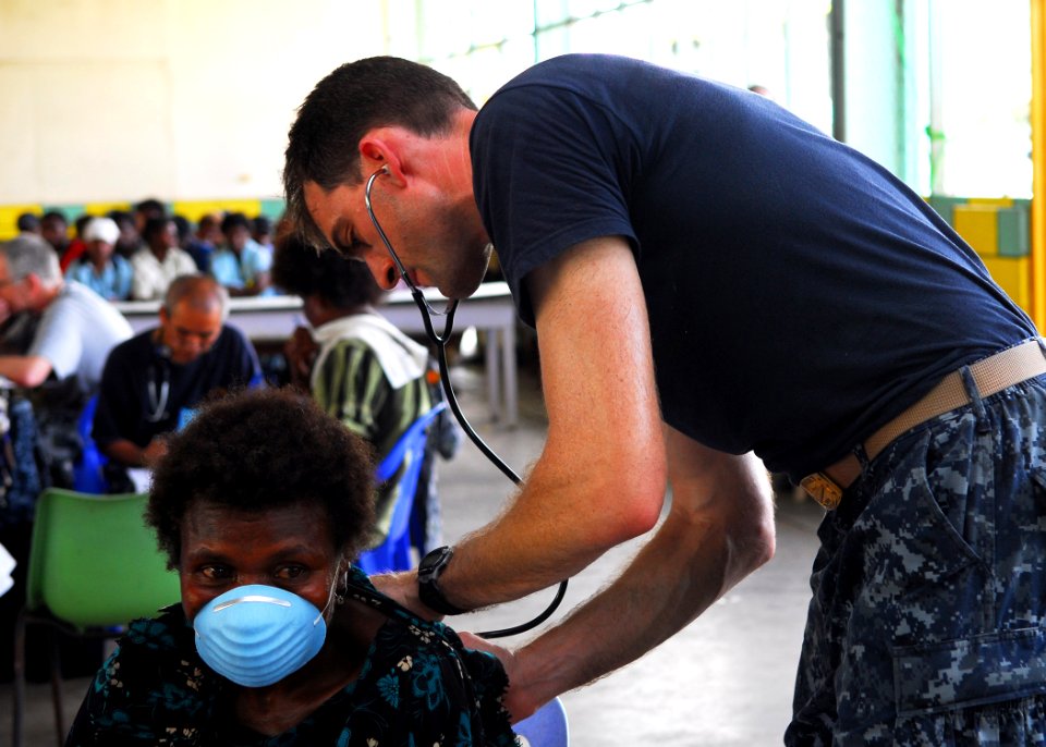 US Navy 100908-N-4044H-203 Cmdr. Peter Shumaker, a doctor embarked aboard the Royal Australian Navy landing ship heavy HMAS Tobruk (L50), examines