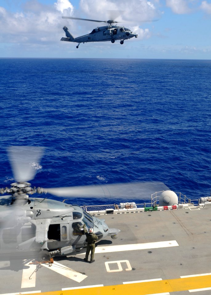 US Navy 100902-N-9950J-009 An MH-60S Sea Hawk helicopter assigned to the Island Knights of Helicopter Sea Combat Squadron (HSC) 25 approaches the flight deck of the forward-deployed amphibious assault ship USS Essex (LHD 2)