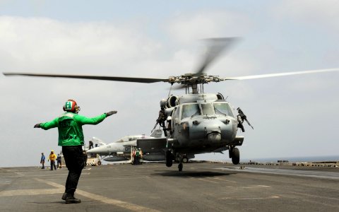 US Navy 100906-N-6362C-107 A landing signals enlisted directs an SH-60F Sea Hawk helicopter aboard USS Harry S. Truman (CVN 75)
