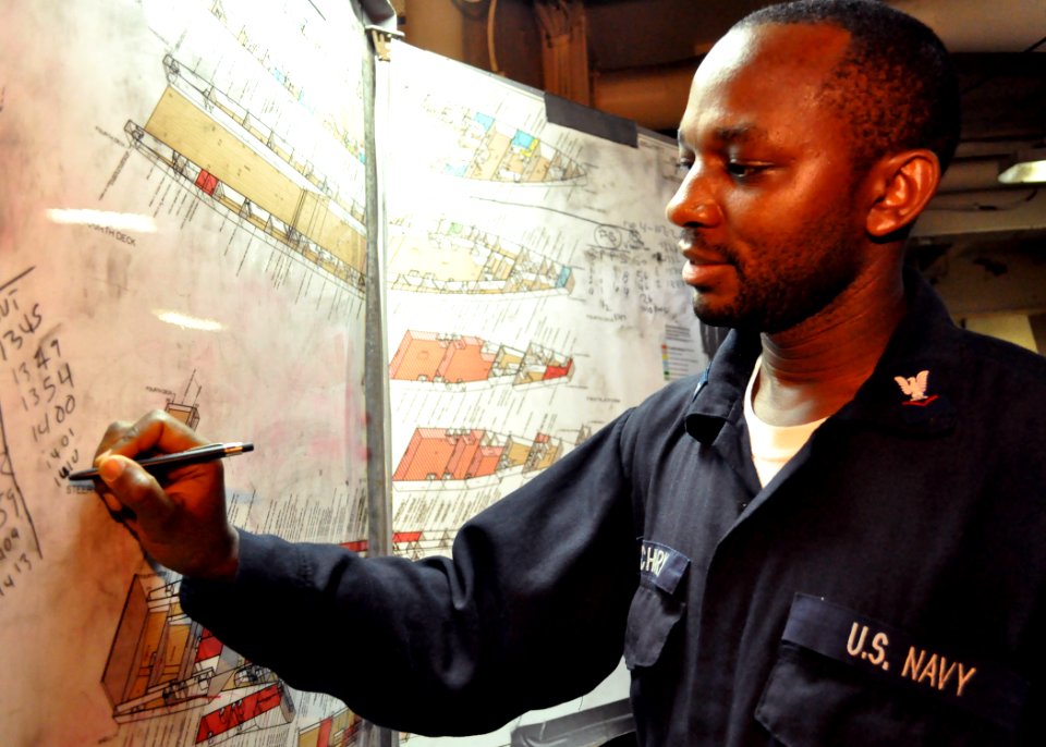 US Navy 100904-N-3620B-028 Machinist's Mate 3rd Class Ephantus W. Macharia plots the status of a simulated flooding casualty during a damage control drill aboard USS Denver (LPD 9)