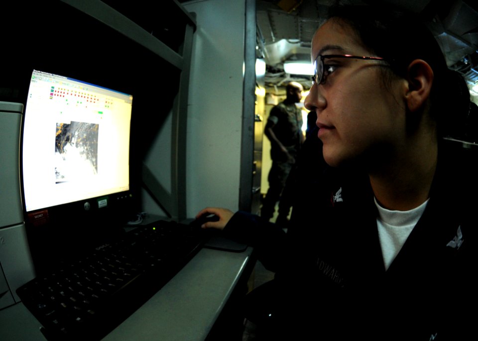 US Navy 100907-N-5538K-014 Aerographer's Mate 3rd Class Bonita M. Edwards reviews satellite imagery in the meteorological office of USS Essex (LHD