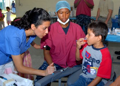 US Navy 100911-N-3265K-052 Hospital Corpsman 2nd Class Breneah B. Bromfield watches a Guatemalan child rinse his mouth photo