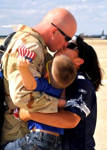 US Navy 100904-N-9565D-065 Aviation Structural Mechanic 2nd Class William Thompson eceives a hug and kiss from his wife and son during a homecoming