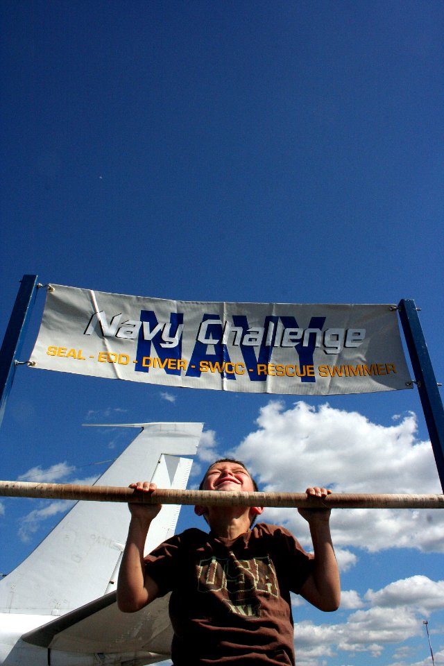 US Navy 100905-N-6220J-110 A visitor to the Cleveland National Air Show attempts the Navy Challenge pull-ups