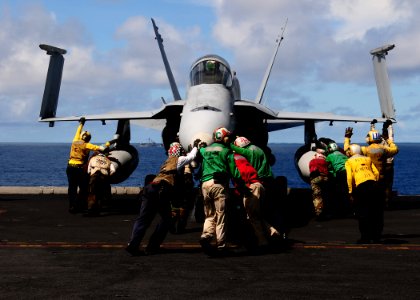 US Navy 100911-N-3327M-085 Sailors assigned to the Sidewinders of Strike Fighter Squadron (VFA) 86 push an F-A-18C Hornet