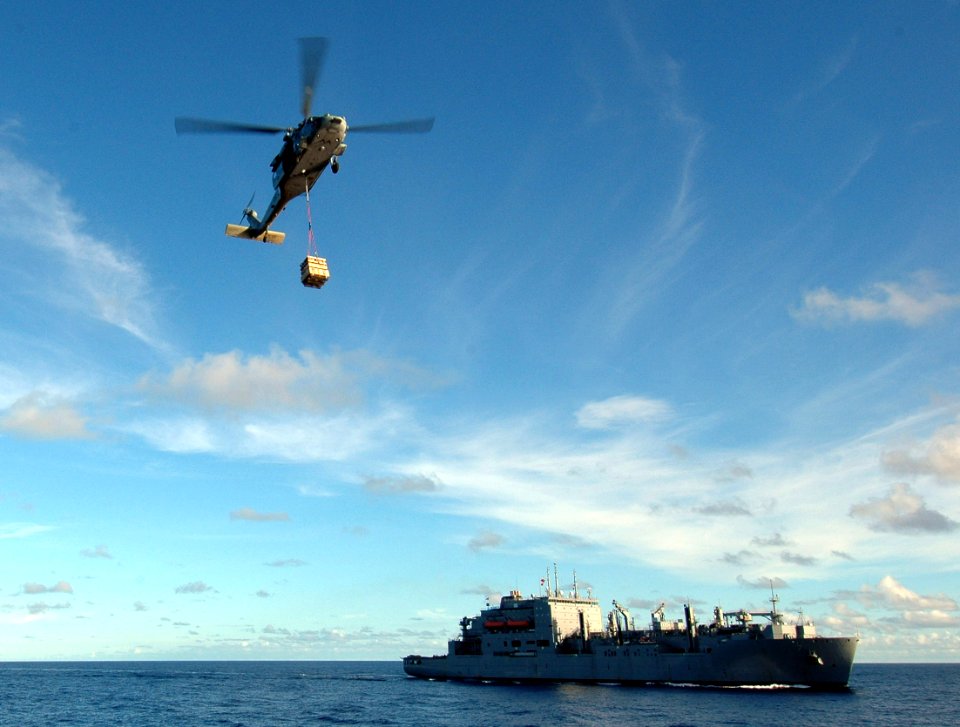 US Navy 100911-N-7191M-104 An MH-60S Sea Hawk helicopter carries supplies from Military Sealift Command dry cargo and ammunition ship USNS Amelia E