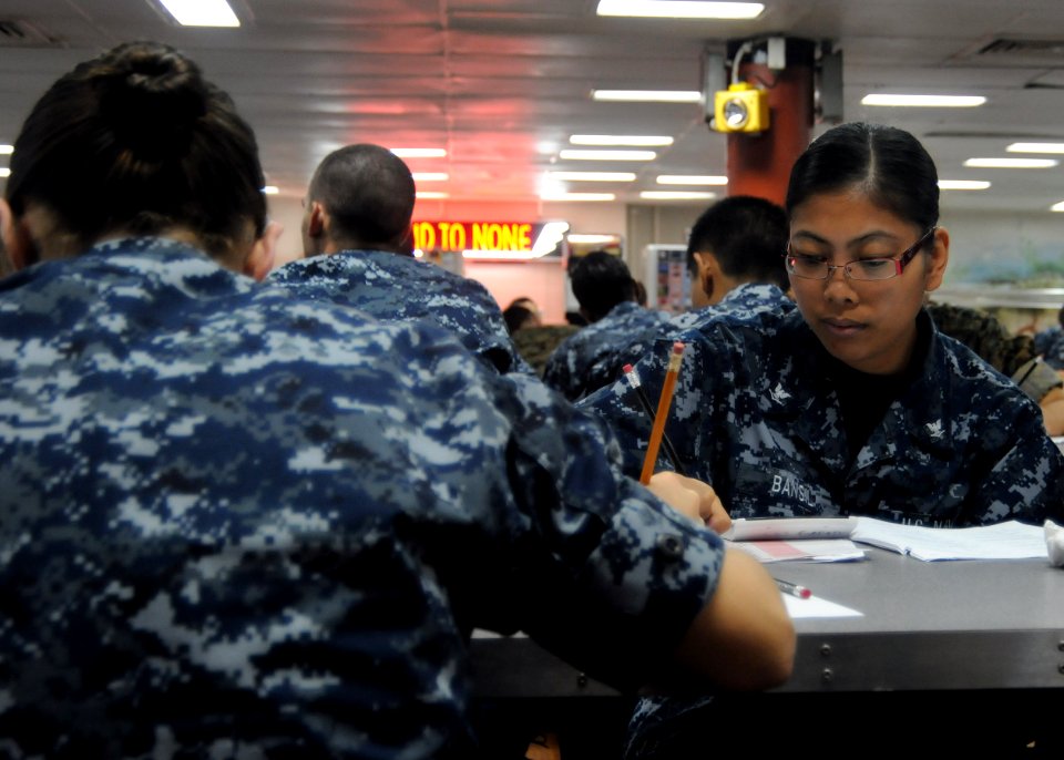 US Navy 100909-N-5215E-021 Culinary Specialist 3rd Class Lea Bansil takes the Navy-wide E-5 exam aboard the forward deployed amphibious assault shi