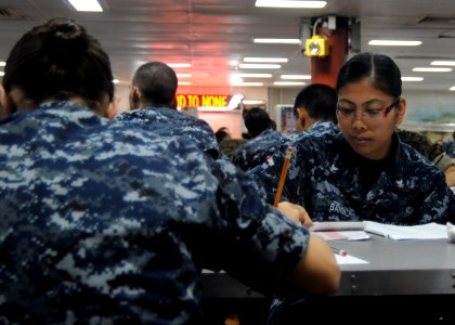 US Navy 100909-N-5215E-021 Culinary Specialist 3rd Class Lea Bansil takes the Navy-wide E-5 exam aboard the forward deployed amphibious assault shi